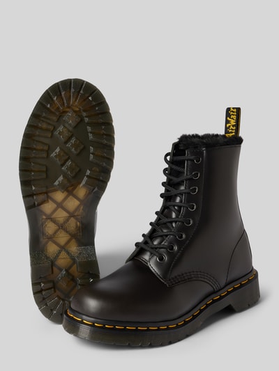 Produktfoto, Boots aus echtem Leder mit Label-Detail Modell 'Serena' von Dr. Martens, schwarze Farbe, strukturierte Sohle, abgerundete Spitze, Schnürverschluss, sichtbare Label-Schlaufe, Damen Schuhe, 4 cm Absatz, Kontext: echtes Leder, Schafthöhe 16 cm, Schaftweite 9 cm.