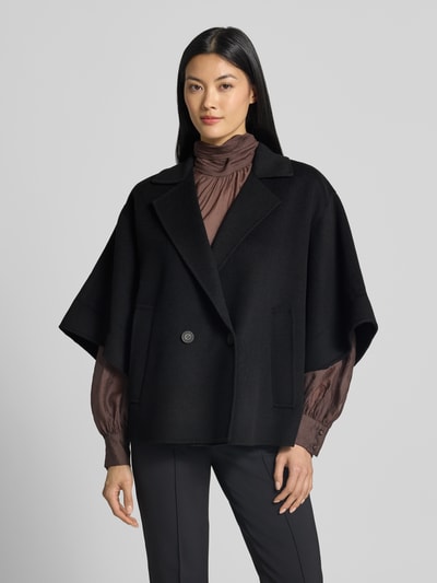 Frauenmodel trägt Regular Fit Kurzmantel aus reiner Schurwolle Modell 'NEO' von Weekend Max Mara, unifarben schwarz, Reverskragen, doppelter 1-Knopf-Verschluss, kurzarm mit Umschlag, seitliche Leistentaschen, gebürstete Textur, Ganzkörperansicht von vorne.