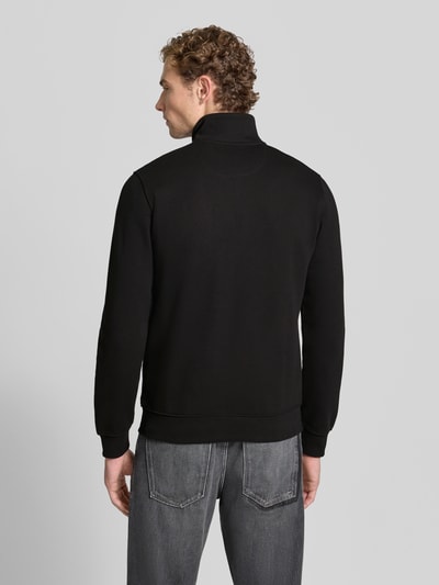 Männermodel trägt schwarze Regular Fit Sweatjacke aus Baumwoll-Mix von s.Oliver RED LABEL, Ganzkörperansicht Rückansicht.