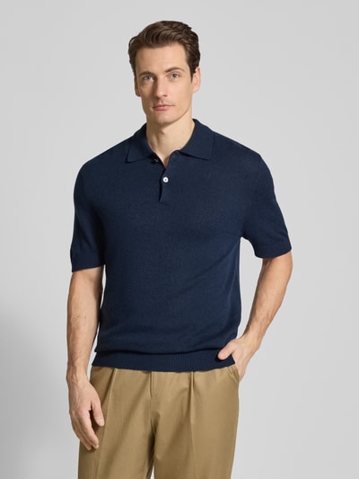 Männermodel trägt Slim Fit Poloshirt mit Kasjmier-aandeel van FTC Cashmere in donkerblauw, katoenmix, polokraag, knoopsluiting, 1/2-mouwen, ruglengte bij maat 50 68 cm, herenmode, ganzkörperansicht van voren.