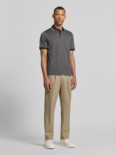 Männermodel trägt Regular Fit Poloshirt mit Polokragen und kurzer Knopfleiste von bugatti, Reine Baumwolle, Label-Detail, Ganzkörperansicht von vorne.