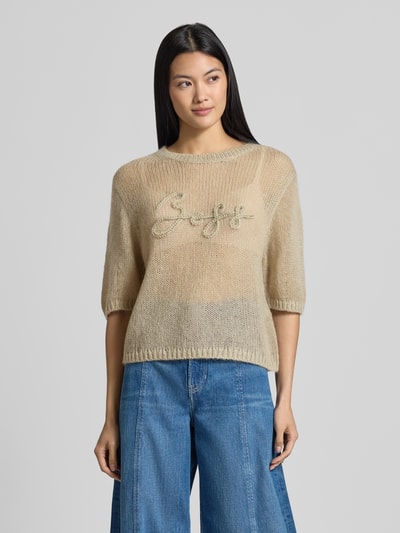 Frauenmodel trägt Regular Fit Pullover aus Schurwoll-Modal-Mix Modell 'C_Farezza' von BOSS Orange in Beige mit Stickerei, Damen Pullover, Ganzkörperansicht von vorne.
