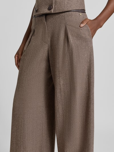 Frauenmodel trägt Wide Leg Hose aus Schurwoll-Mix mit Eingrifftaschen von Armani Exchange, braune Farbe, feine Textur, Nahaufnahme Oberkörper. Damen Hose mit Seiden-Anteil, Knopfverschluss, Bundweite 36 cm, Innenbeinlänge 83 cm.