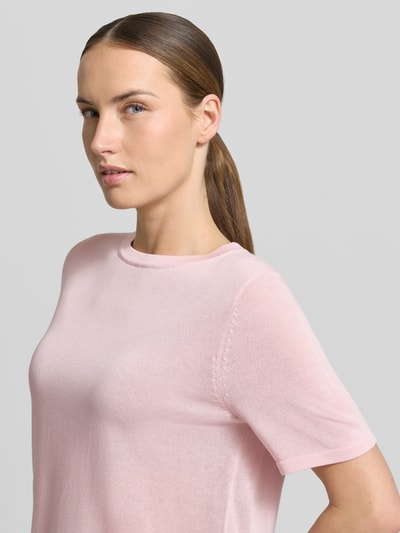 Frauenmodel trägt T-Shirt mit Rundhalsausschnitt Modell 'TENCYM' von Mango in zartem Rosa, Material-Mix mit Lyocell, Nahaufnahme Oberkörper.