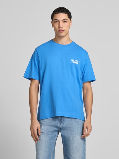 Männermodel trägt Herren T-Shirt mit Statement-Print Modell 'NORREBRO' von Jack & Jones, Reine Baumwolle, Gerader Schnitt, Rundhalsausschnitt, Rückenlänge 68 cm, Ganzkörperansicht von vorne.