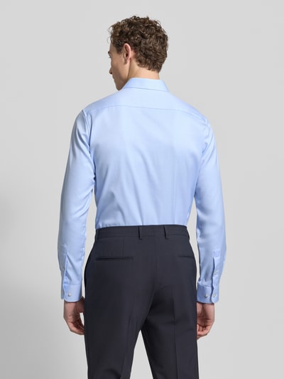 Männermodel trägt Slim Fit Businesshemd aus Twill von Eterna in Hellblau, reine Baumwolle, Haifischkragen, feine Webstruktur, Ganzkörperansicht Rückansicht.