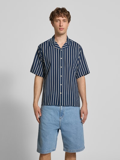 Männermodel trägt Regular Fit Freizeithemd mit Reverskragen Modell 'HOWIE' von Redefined Rebel, Allover-Look, Reine Baumwolle, Ganzkörperansicht von vorne. Rückenlänge 60 cm, Schulterbreite 60 cm, Ärmellänge 30 cm, Label-Detail.