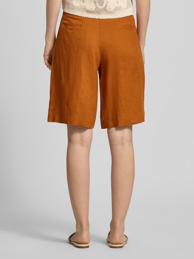 Frauenmodel trägt Bermudas aus Leinen mit Gesäßtaschen von Christian Berg Woman, rostbraun, Regular Fit, Ganzkörperansicht Rückansicht.