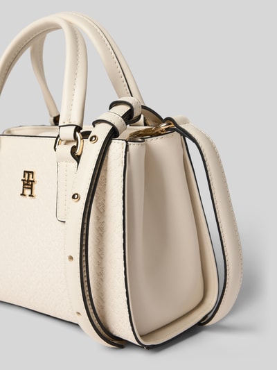 Produktfoto, Henkeltasche mit Allover Logo-Prägung von Tommy Hilfiger aus cremefarbenem Kunstleder, Logo-Detail, Tragehenkel, abnehmbarer Schulterriemen, Hauptfach mit Magnetverschluss, strukturierte Oberfläche mit feiner Prägung