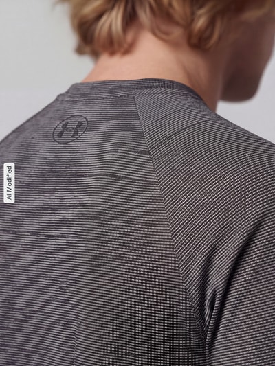 Männermodel trägt Regular Fit Sport-T-Shirt mit Logo-Print von Under Armour, feine graue Struktur, Nahaufnahme Oberkörper, KI-modifiziertes Bild.