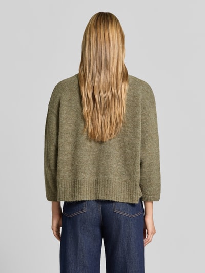 Frauenmodel trägt Oversized Pullover mit Alpaka-Anteil Modell 'East' von American Vintage in Strick-Optik, Rückansicht, elastischer Material-Mix