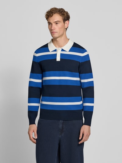 Männermodel trägt Regular Fit Poloshirt aus Viskose-Mix von MCNEAL, gestreift in Blau und Weiß, langärmelig, Ganzkörperansicht von vorne.