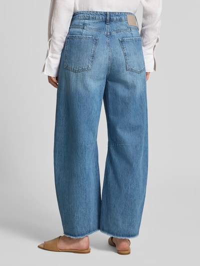 Frauenmodel trägt Barrel Fit Jeans mit Fransen von Rich & Royal in hellem Blau, reine Baumwolle, Used-Look, Eingrifftaschen, Ganzkörperansicht Rückansicht.