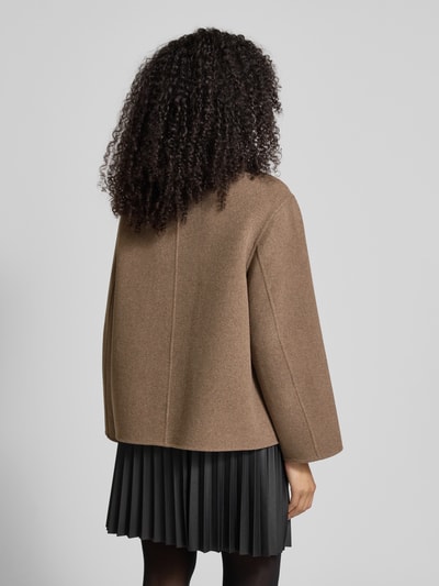 Modelka nosi Jacke mit Stehkragen od Jake*s Collection, brązowy materiał z domieszką wełny, luźny krój, widok całej sylwetki z tyłu.