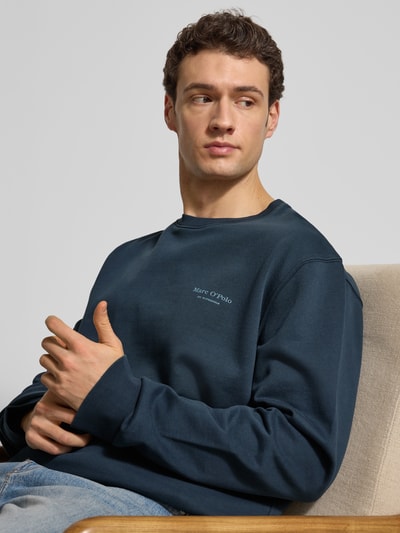 Männermodel trägt Regular Fit Sweatjacke aus reiner Baumwolle von Marc O'Polo in Dunkelblau, unifarben, Nahaufnahme Oberkörper.