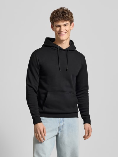 Männermodel trägt Regular Fit Hoodie aus Baumwoll-Mix Modell 'CERES' von Only & Sons, Optik: Unifarben, Kängurutasche, Kapuze, Langarm, Gerippt, Ganzkörperansicht von vorne.
