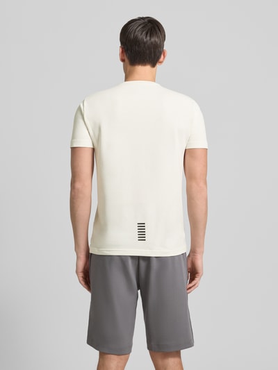 Männermodel trägt T-Shirt mit Label-Print van EA7 Emporio Armani in offwhite, katoen-elastaanmix, slim fit, rugaanzicht, ruglengte 68 cm.