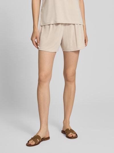 Kobiece model nosi Relaxed Fit Stoffshorts aus Viskose-Mix model 'ANORA' od PIECES, jednolita beżowa tkanina, matowa tekstura, Ganzkörperansicht z przodu.