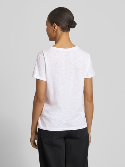Frauenmodel trägt T-Shirt mit Ziersteinbesatz und Rundhalsausschnitt von monari, weiß, Regular Fit, Rückenlänge 58 cm, Ganzkörperansicht Rückansicht.
