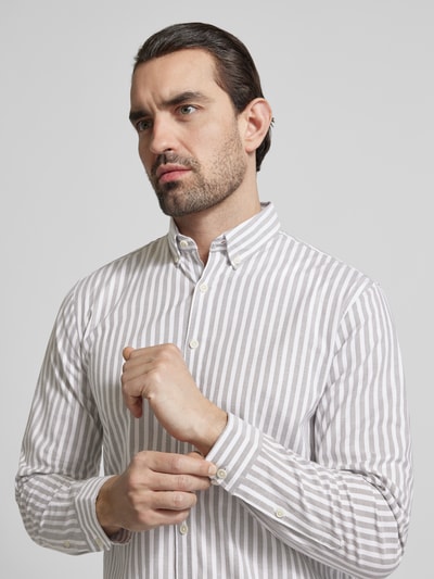 Männermodel trägt Relaxed Fit Freizeithemd mit Button-Down-Kragen von Lindbergh, Material-Mix mit Stretch-Anteil, Streifenmuster, Nahaufnahme Oberkörper.