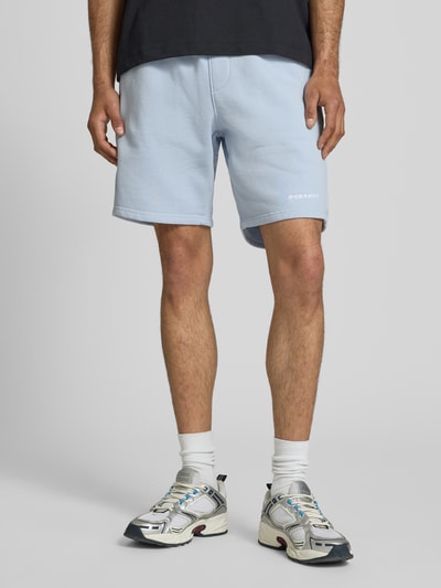 Männermodel trägt Regular Fit Shorts mit Logo-Stitching von Pegador aus hellblauem Baumwoll-Mix, elastischer Bund, Ganzkörperansicht von vorne.