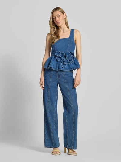 Frauenmodel trägt Jeanstop mit floralen Applikationen von YAS aus Reine Baumwolle, Taillierter Schnitt, Modell ELSIE, Karree-Ausschnitt, Rückenlänge bei Größe 36: 33 cm in Mittelblau mit Jeans, Ganzkörperansicht von vorne.