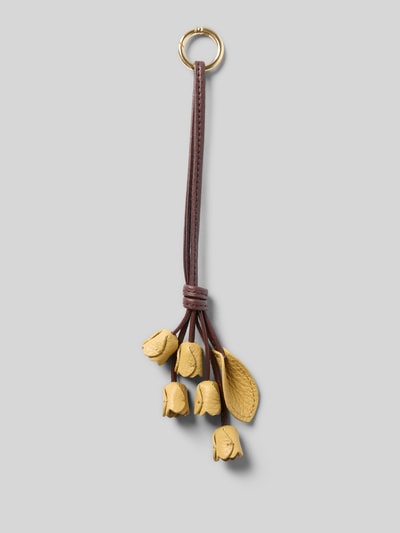 Produktfoto, Schlüsselanhänger in floralem Design von Coccinelle mit Strukturmuster, Karabinerhaken, Knoten-Optik, gelb-braune Farben.