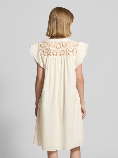 Frauenmodel trägt Relaxed Fit Minikleid mit Loch-Stickerei von ROBE LÉGÈRE in Creme, Tunika-Ausschnitt, reine Baumwolle, Rückansicht, Ganzkörperansicht.