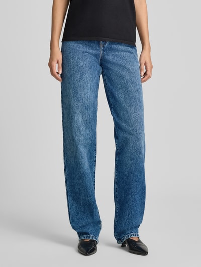 Frauenmodel trägt Straight Fit Jeans aus reiner Baumwolle von Emporio Armani, mittleres Blau, 5-Pocket-Design, Ganzkörperansicht von vorne.
