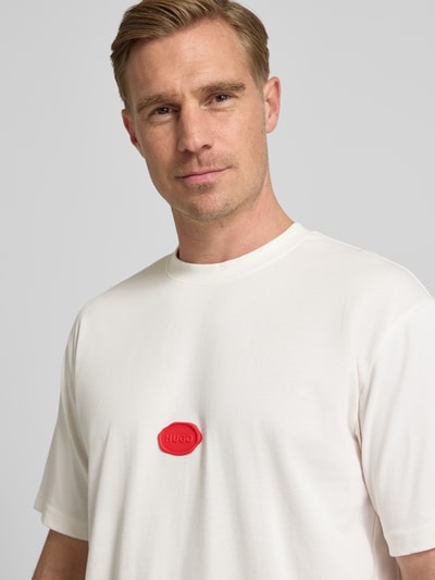 Männermodel trägt Relaxed Fit T-Shirt aus Baumwoll-Jersey Modell 'DIVIS' von HUGO, Optik: unifarben, Applikation: Wachsstempel-Label, Rundhals, Kurzarm, Materialverarbeitung: Jersey, Material: reine Baumwolle, Nahaufnahme Oberkörper
