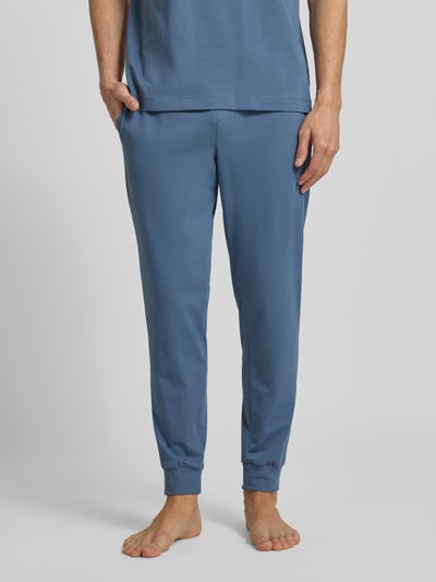 Männermodel trägt Regular Fit Sweathose aus Baumwoll-Mix Modell 'LAZE' von HUGO, unifarben, elastischer Bund, Nahaufnahme Unterkörper.