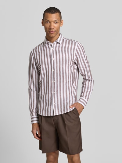 Männermodel trägt Slim Fit Business-Hemd mit Kentkragen Modell 'Pit' von JOOP! Collection, gestreift, Baumwoll-Leinen-Mix, Ganzkörperansicht von vorne.