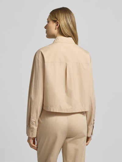 Modelka nosi Boxy Fit Bluse mit Brusttaschen von Marc Cain z bawełny, pudełkowy krój, kołnierzyk koszulowy, brustasze, długość tyłu 51 cm, długość rękawów 57 cm, widok całej sylwetki z tyłu.