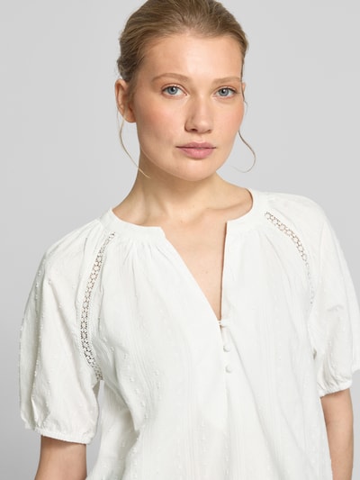 Kobiece modelka nosi Loose Fit Bluse aus reiner Baumwolle Modell 'JUTTY' von Vero Moda, biała, strukturalna tkanina, haft, Henley, krótki rękaw, bliższe ujęcie górnej części ciała