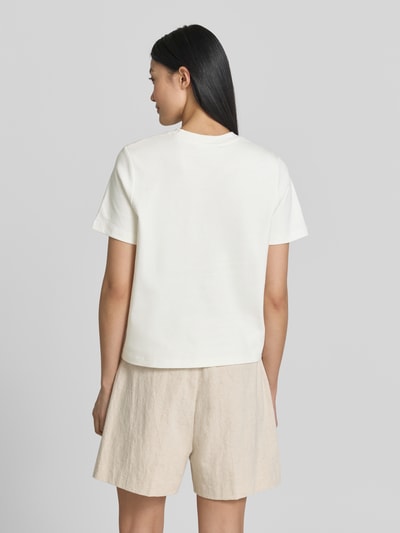 Frauenmodel trägt T-Shirt mit floralen Applikationen von Christian Berg Woman in Reine Baumwolle, Gerader-Schnitt, Rundhalsausschnitt, 1/2-Arm, natürliche Farben, Rückenlänge bei Größe S: 52 cm, Ganzkörperansicht Rückansicht.