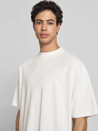 Mężczyzna model nosi Oversized T-Shirt mit Rundhalsausschnitt od PROHIBITED, czysta bawełna, biała, szerokie ramiona, oversize, długość tyłu w rozmiarze M: 69 cm, półzbliżenie na górną część ciała