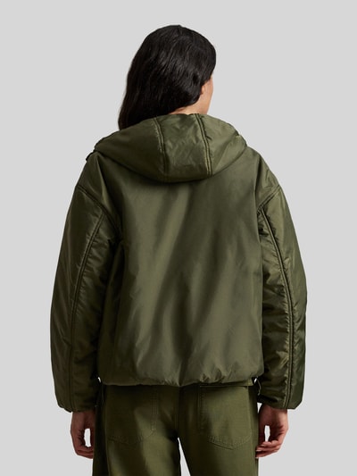 Männermodel trägt Relaxed Fit Blouson mit Zweiwege-Reißverschluss von Polo Ralph Lauren, kolor jednolity, kaptur, elastyczny dół, widok całej sylwetki od tyłu.