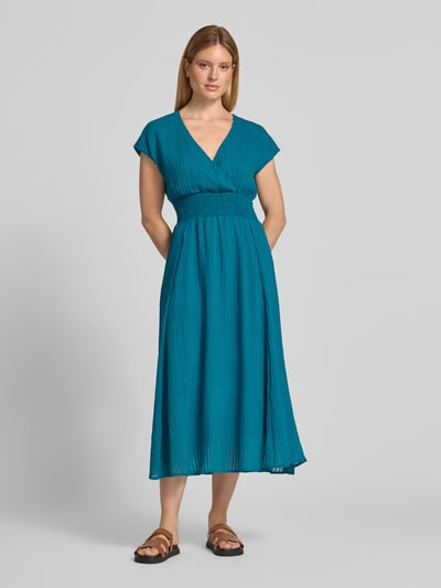 Frauenmodel trägt Midikleid aus Viskose-Mix mit Smok-Details von zero in Türkis, Strukturmuster, tailliert, V-Ausschnitt, Ganzkörperansicht von vorne.