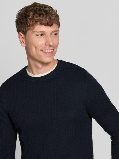 Männermodel trägt Regular Fit Pullover aus reiner Baumwolle Modell 'Adrian' von Strellson in Dunkelblau, strukturierte Oberfläche, Nahaufnahme Oberkörper, Herren Pullover von Strellson.