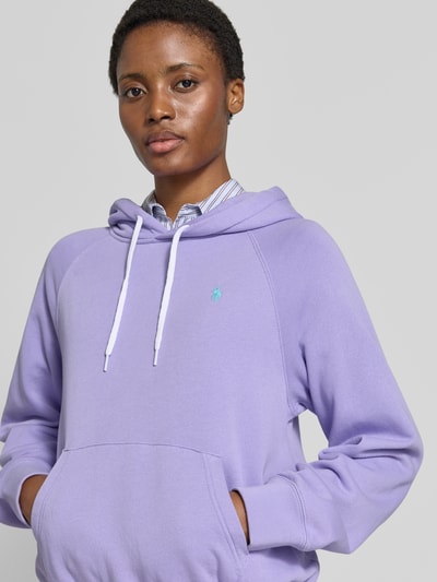 Vrouwenmodel draagt Comfort Fit Hoodie uit katoenmix van Polo Ralph Lauren in lichtpaars, zachte textuur, Nahaufnahme Oberkörper. Dames hoodie