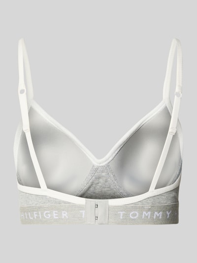 Frauenmodel trägt BH mit Logo Bund Modell 'RIB BRALETTE LIFT' von TOMMY HILFIGER, mehrfarbig, detailreiche Struktur, Ganzkörperansicht Rückansicht.