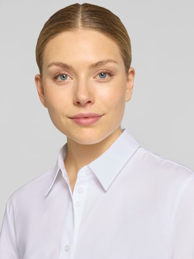 Kobiece model prezentuje Regular Fit mit Puffärmeln von More & More, mieszanka bawełny z dodatkiem streczu, kołnierzyk koszulowy, bufiaste rękawy, długość tyłu 64 cm, długość rękawów 26 cm, bluzka biała, gładka faktura, zbliżenie na górną część ciała.