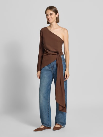 Kobieta modelka nosi bluzkę im One-Shoulder-Design aus Modal-Mix od Topshop, mieszanka modalu, dopasowany krój, marszczenie z trenem w talii, odkryte i długie rękawy, długość tyłu 53 cm, długość rękawów 56 cm, brązowy kolor, prosta faktura, pełny widok z przodu.