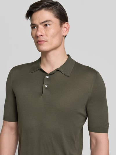 Männermodel trägt Slim Fit Poloshirt aus reiner Seide von GRAN SASSO in Khaki, semitransparent, kurzärmelig, Nahaufnahme Oberkörper.