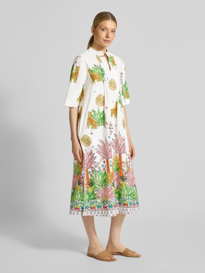 Frauenmodel trägt Midikleid mit V-Ausschnitt von Emily Van den Bergh aus Reine Baumwolle, Gerader-Schnitt, 3/4-Arm, buntem Print, Ganzkörperansicht von vorne.