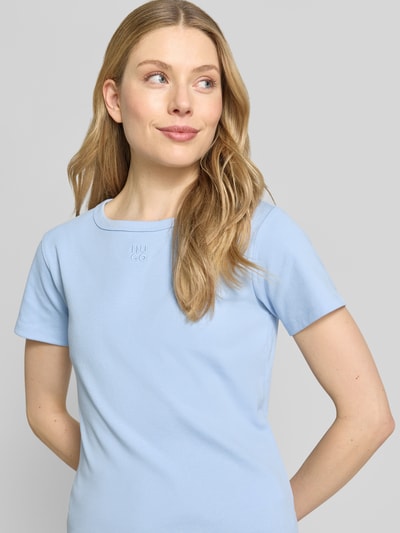 Frauenmodel trägt Regular Fit T-Shirt aus Baumwoll-Mix Modell 'DELORIS' von HUGO in Hellblau, glatte Jerseyoberfläche, Nahaufnahme Oberkörper.