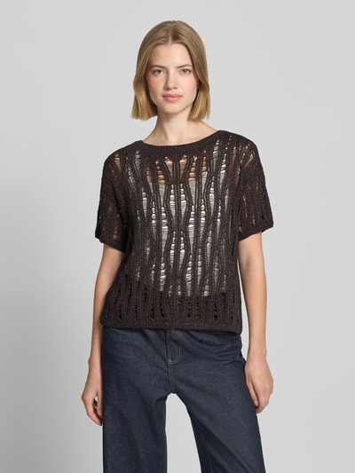 Frauenmodel trägt T-Shirt in semitransparentem Design Modell 'Ajour' von monari, Strick-Optik, tailliert, kurzärmelig, Rundhalsausschnitt, Ganzkörperansicht von vorne.