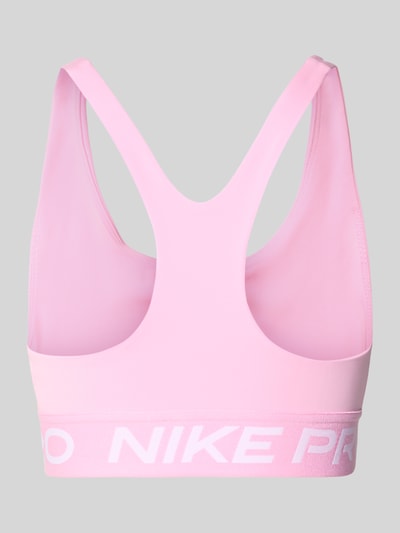 Produktfoto, Sport-BH mit Label-Bund von Nike in Rosa mit glatter Oberfläche und weißem Schriftzug vor grauem Hintergrund. Kontext: Damen Sport-BH von Nike