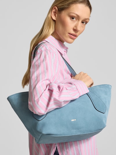Frauenmodel trägt Handtasche in Flecht-Optik Modell 'Carina' von Abro in Hellblau, strukturierte Oberfläche, Ganzkörperansicht von vorne. Hauptfach mit Reißverschluss, abnehmbarer Schulterriemen, Maße 47x24x15 cm, Schulterriemen 58 cm.
