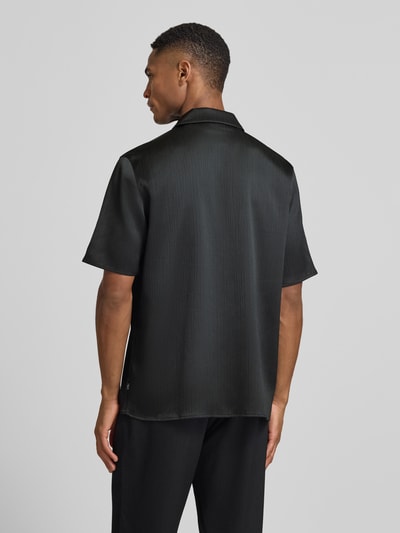 Męski model nosi Regular Fit Freizeithemd mit Kentkragen Modell 'Hector' od Les Deux, plisowany materiał, czarny, widok całej sylwetki z tyłu.